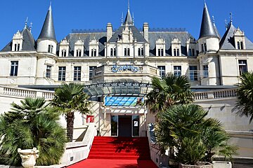 a chateau style building with a red carpet