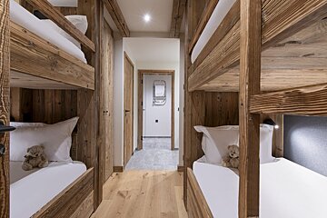 A bedroom with bunk beds and two teddy bears