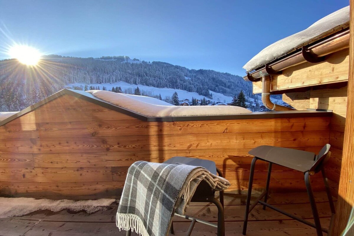 The sun is shining through the snow on the roof