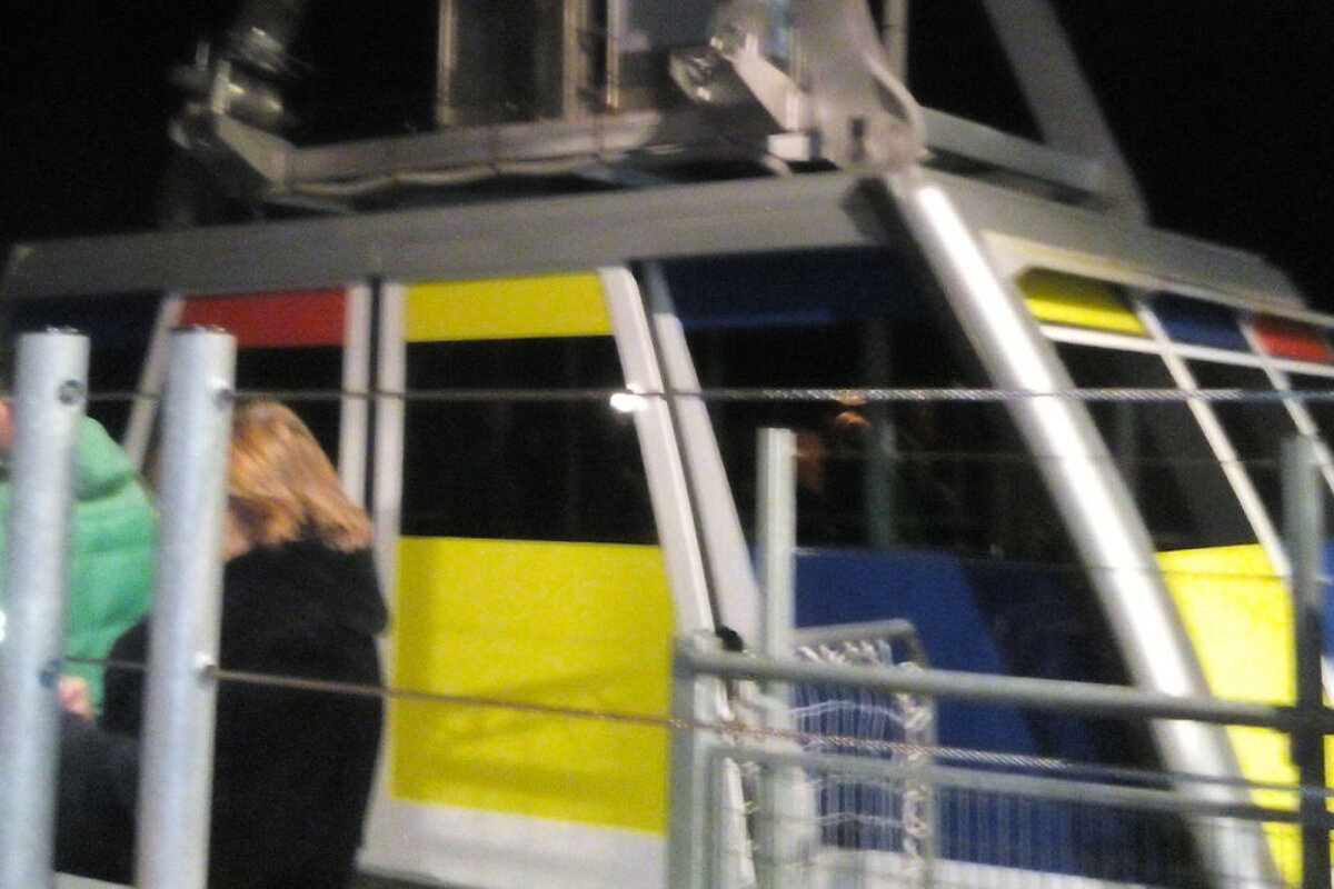 Multicoloured cabin, at night, some people