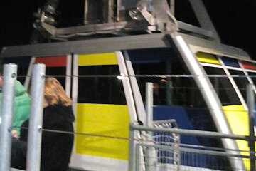 Multicoloured cabin, at night, some people