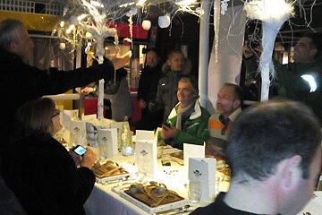 People sitting around the white table with a decorative white centrepiece inside a cabin