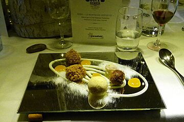 Solar system dessert on a mirror, spoon and glasses