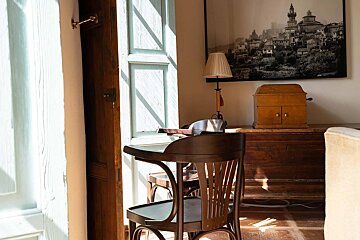 A chair in a room with a picture on the wall above it