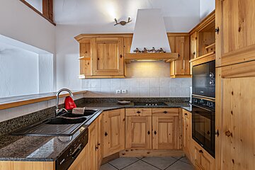 A kitchen with wooden cabinets and a bosch dishwasher