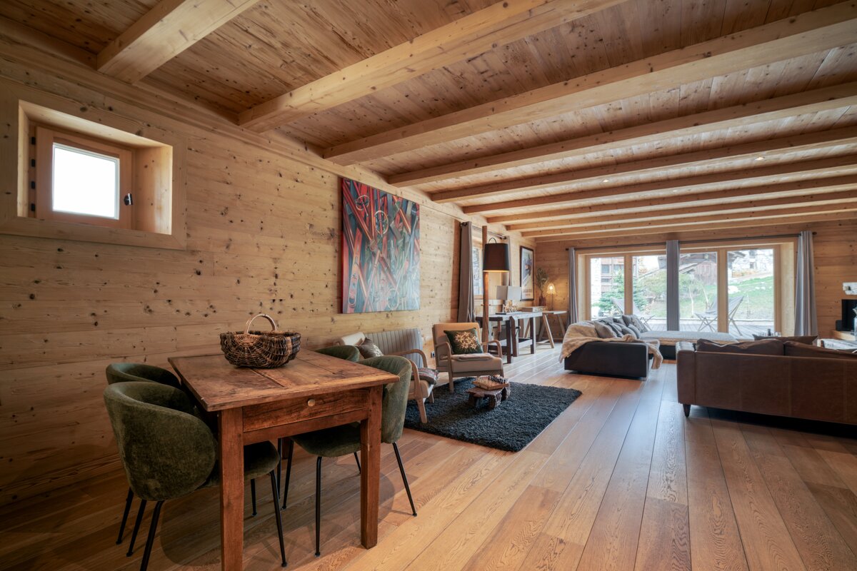 A living room with a wooden table and chairs
