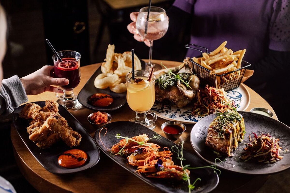 A table with plates of food and drinks on it