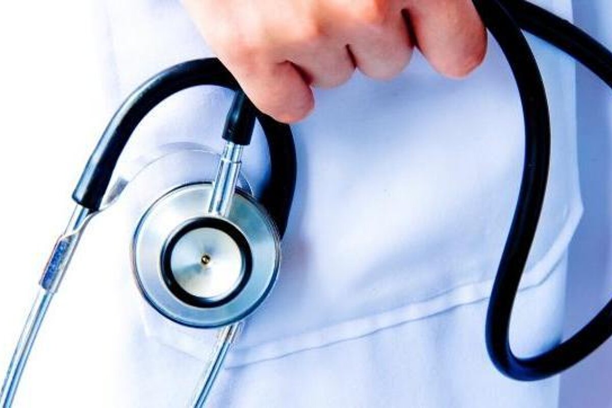 A doctor is holding a stethoscope in his pocket