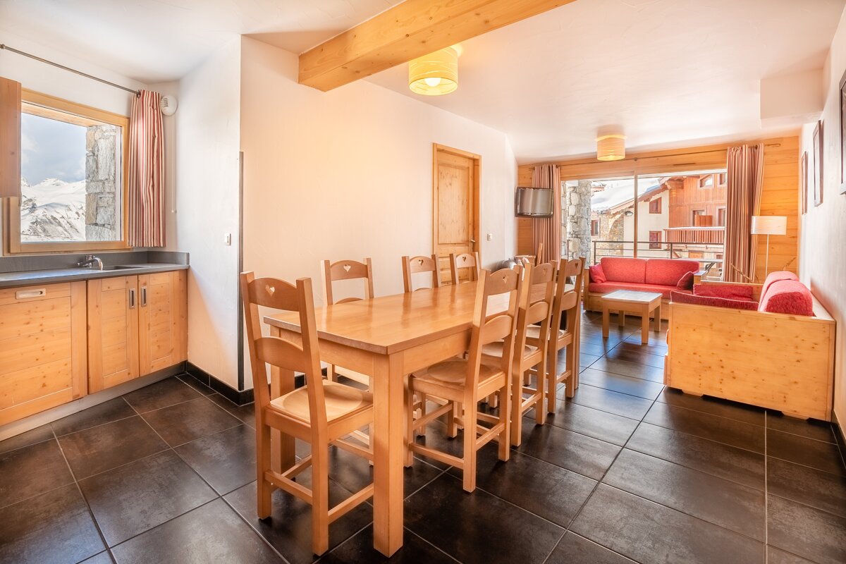 A living room with a table and chairs and a couch