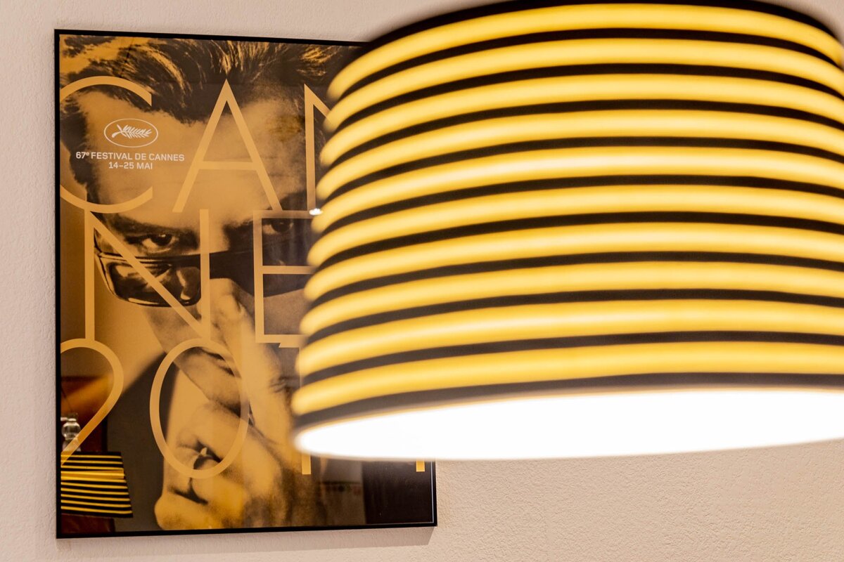 A poster for the cannes film festival hangs on a wall