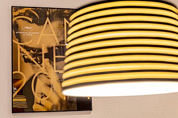 A poster for the cannes film festival hangs on a wall