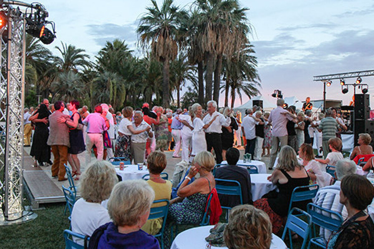 an outdoor stage with couples dancing