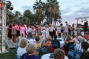 an outdoor stage with couples dancing
