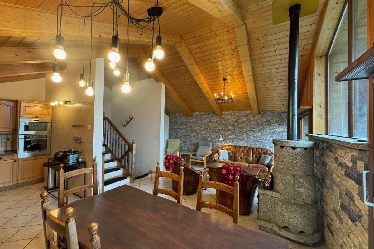A living room with a wooden table and chairs