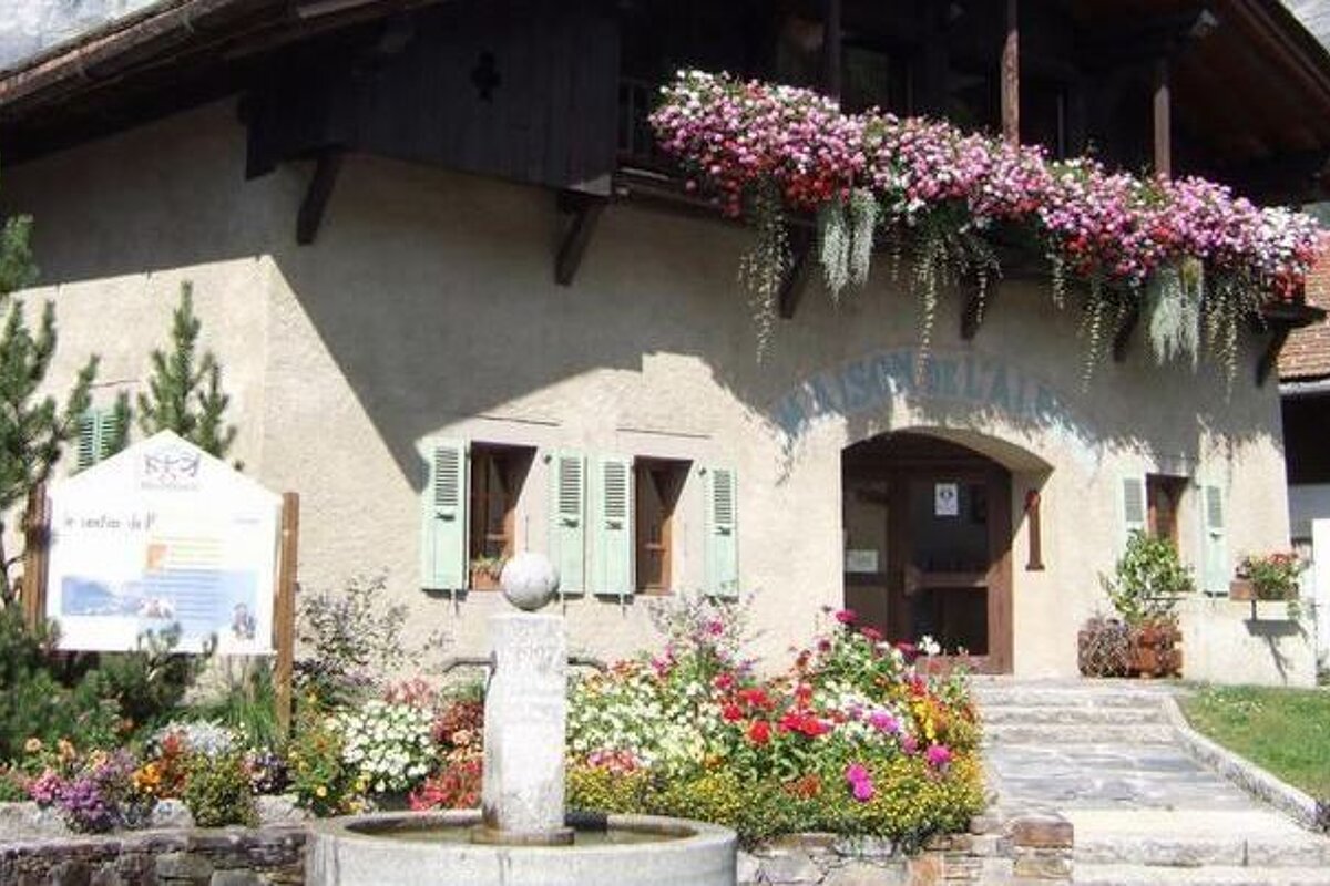 a stone building with lots of flowers outside