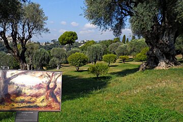 A painting of trees is displayed in a park