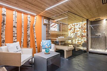 A chair has a pillow that says chalet club on it