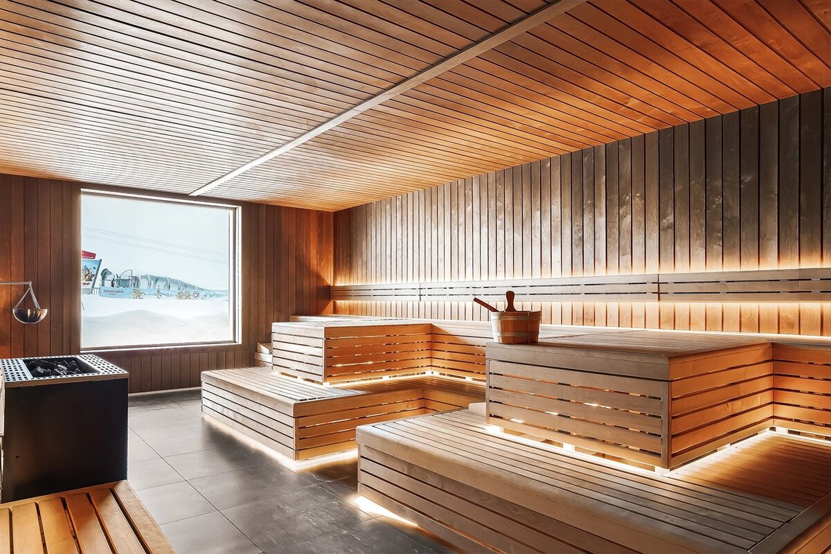 A sauna with wooden benches and a large window