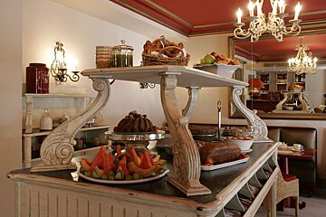 A buffet table with a bottle of tea on it
