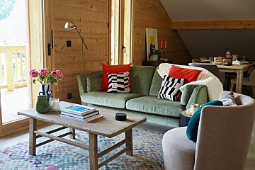 A living room with a green couch and a coffee table