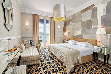 A hotel room with a large bed and a couch