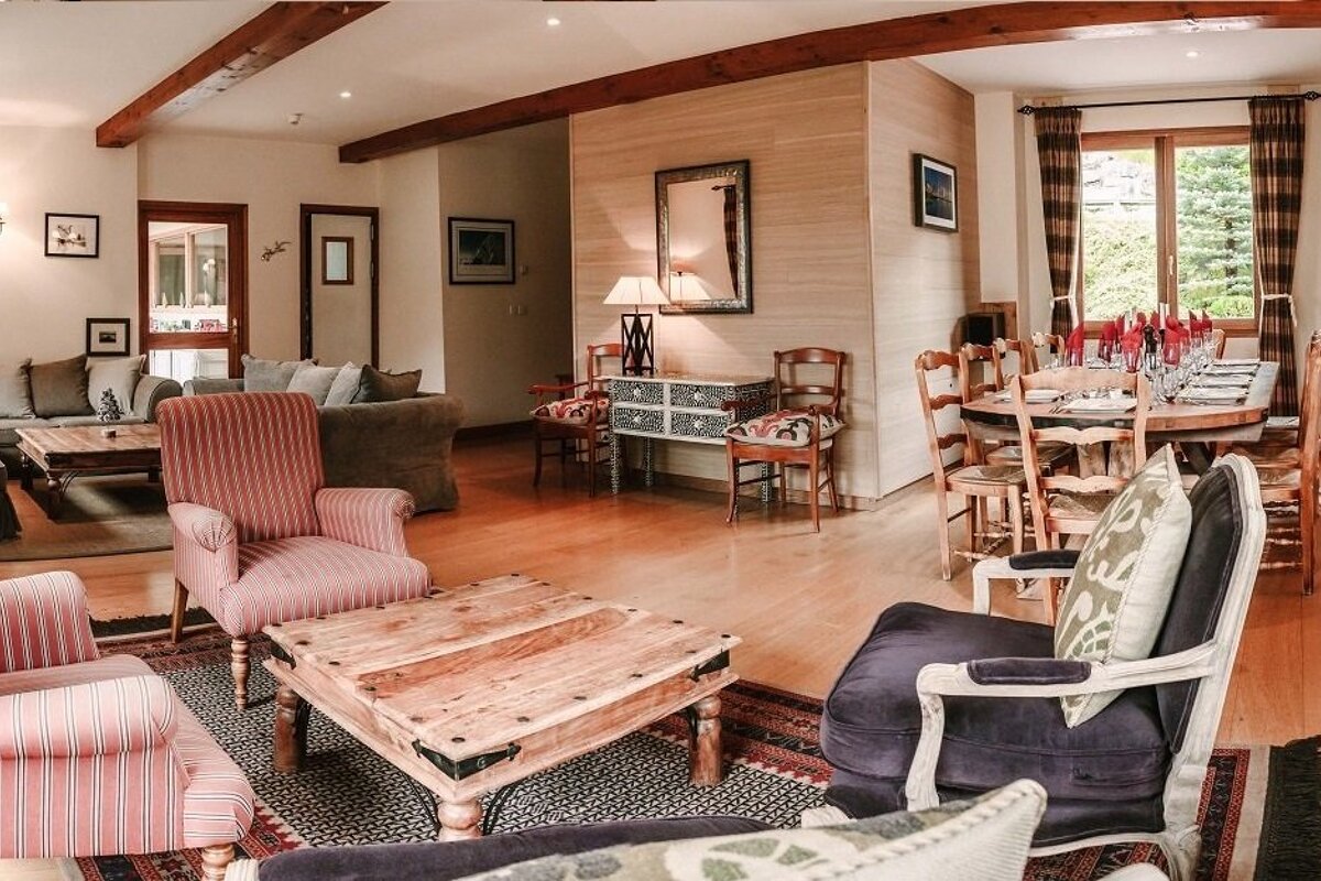 A living room with a wooden table and chairs