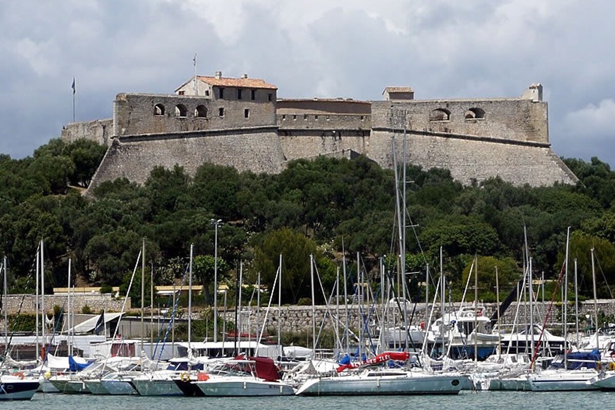 yachts in harbour with an ancient fort in the background