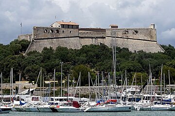 yachts in harbour with an ancient fort in the background