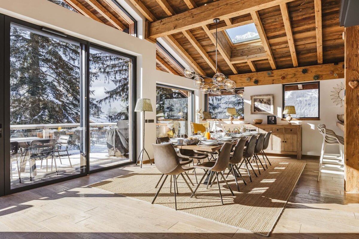 A dining room with a large table and chairs