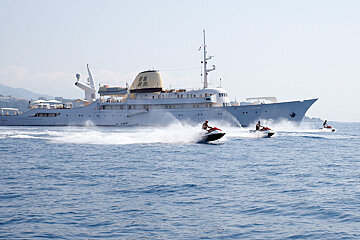a yacht and jetskis in the ocean