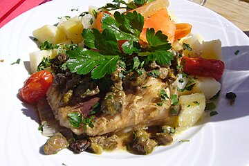 A plate of food with potatoes carrots and tomatoes