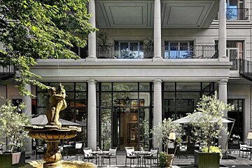 A large building with a fountain in front of it