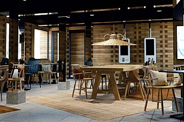A restaurant with a wooden table and chairs
