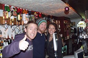 A group of people are posing for a picture in a bar