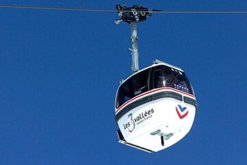 an image of blue sky and 3 valleys gondola