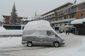 an image of car with huge amounts of snow on roof