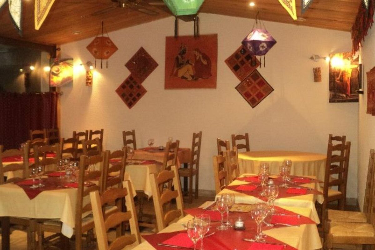 a picture of restaurant tables in an indian restaurant