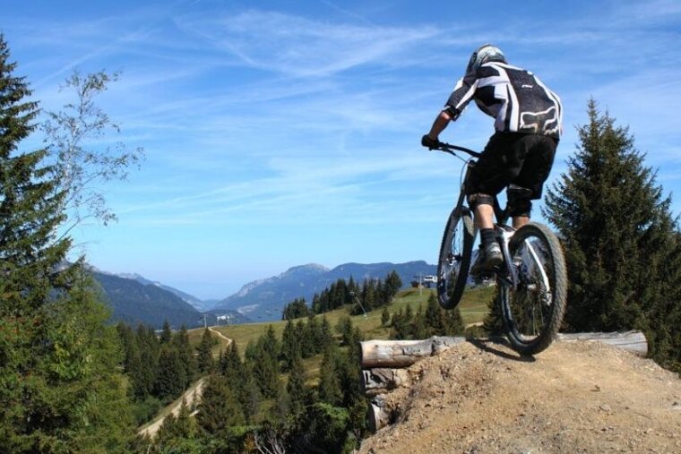 a picture of a mountain biker going over a jump