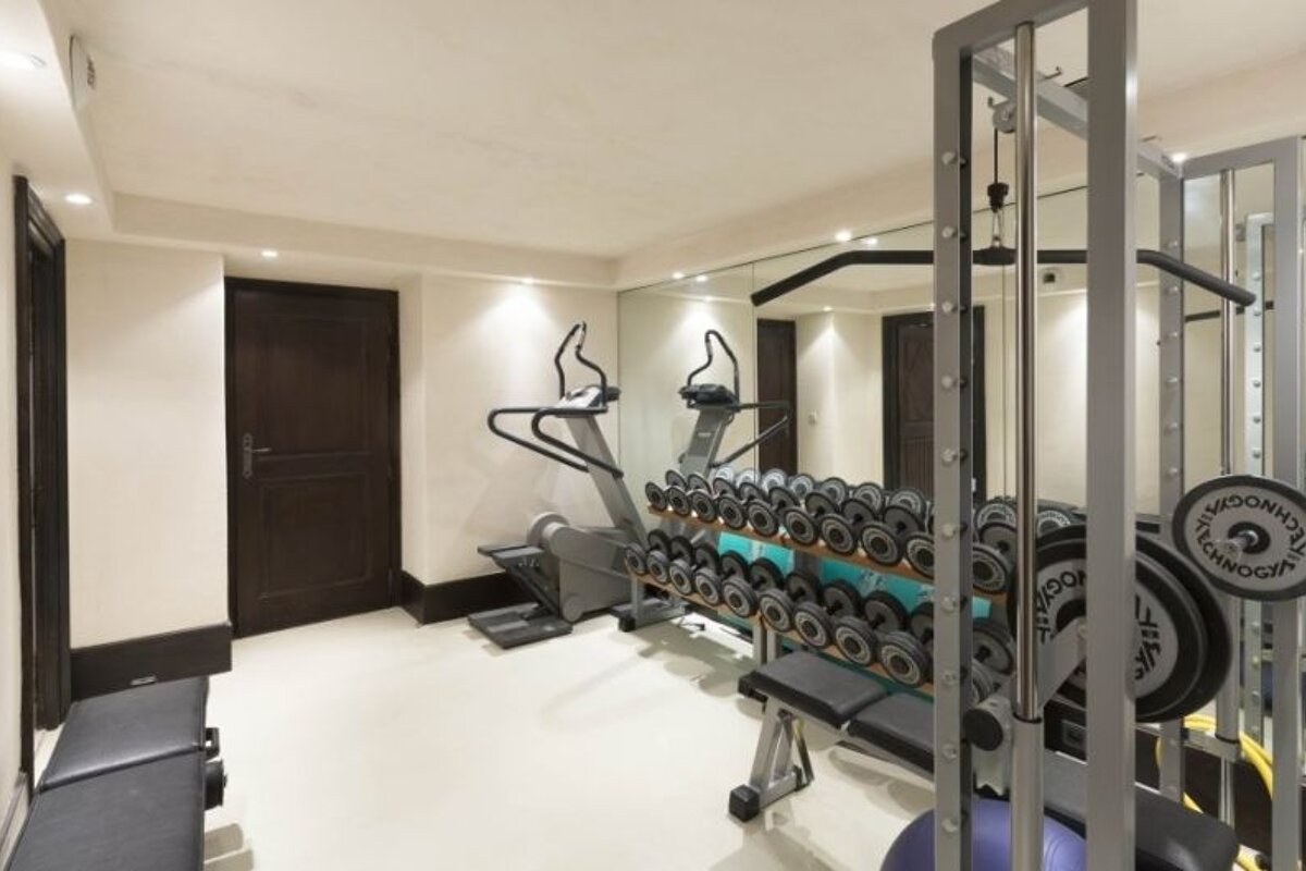 a picture of a gym in a chalet with lots of free weights