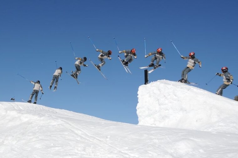 a young skier going over a jump on skis