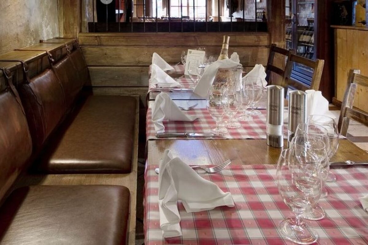 A table with a checkered table cloth and glasses on it