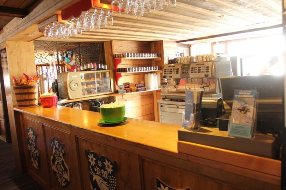 A counter in a restaurant with a sign that says