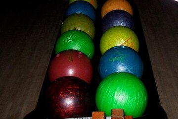 an image of bowling balls in a bowling alley