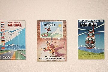 Five posters on a wall one of which says vol07