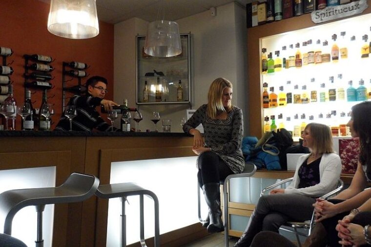 An image of a group of people drinking wine at a bar in Chamonix Mont Blanc