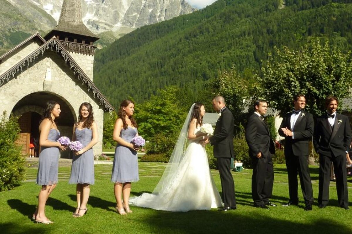 a picture of a bridal party outside a church in les praz chamonix