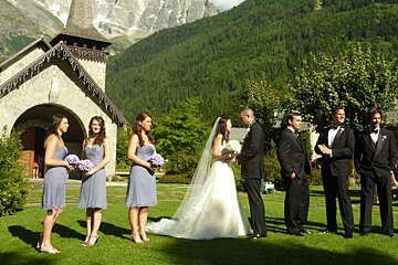 a picture of a bridal party outside a church in les praz chamonix