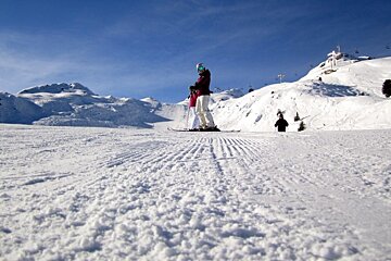 an image of fresh corduroy pistes with skiers on them