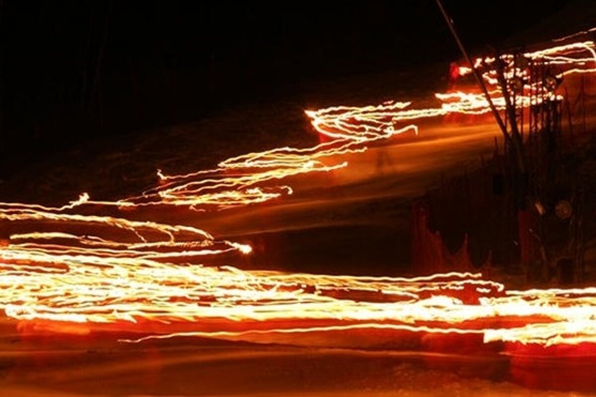 blurry lights from torchlight descent ski resort