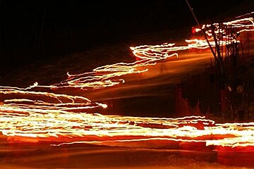 blurry lights from torchlight descent ski resort